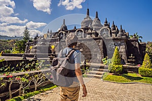 Young man tourist in budhist temple Brahma Vihara Arama Banjar Bali, Indonesia