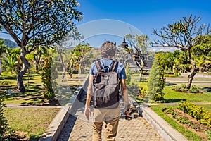 Young man tourist in budhist temple Brahma Vihara Arama Banjar Bali, Indonesia