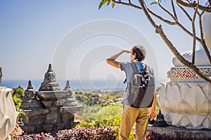 Young man tourist in budhist temple Brahma Vihara Arama Banjar Bali, Indonesia