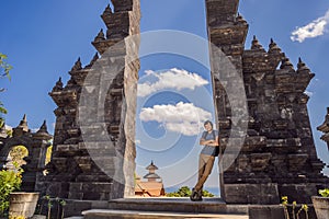 Young man tourist in budhist temple Brahma Vihara Arama Banjar Bali, Indonesia