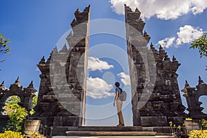 Young man tourist in budhist temple Brahma Vihara Arama Banjar Bali, Indonesia