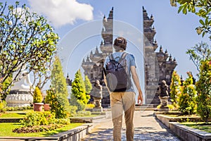 Young man tourist in budhist temple Brahma Vihara Arama Banjar Bali, Indonesia