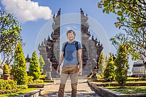 Young man tourist in budhist temple Brahma Vihara Arama Banjar Bali, Indonesia