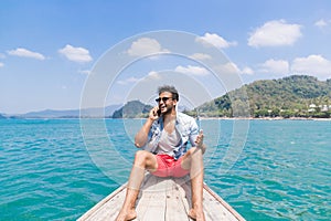 Young Man Tourist Sail Long Tail Thailand Boat Speak Cell Smart Phone Call Ocean Sea Vacation Travel Trip