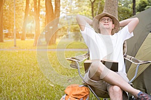 Young man tourist sitting on chair resting and relaxing in front