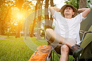 Young man tourist sitting on chair resting and relaxing in front