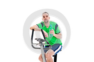 Young man train with fitness machine and drinking water