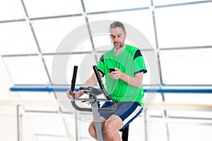 Young man train with fitness machine and listening music