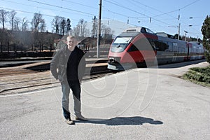 Young man on the the train platform. Salzburgerland, Austria.