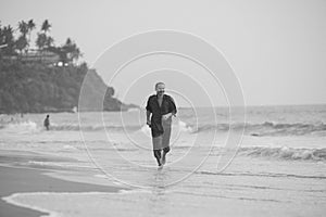 Young man training on the beach in morning. Young man on morning run outdoors.