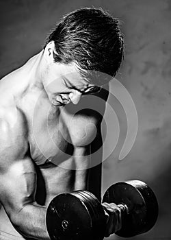 Young man training with dumbell