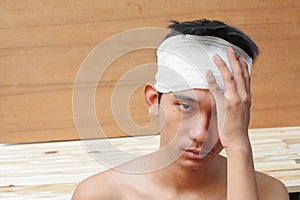 Young man with trauma of the head. by Medical bandage