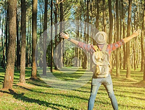 Young Man Traveler with backpack open arm relaxing outdoor on ba