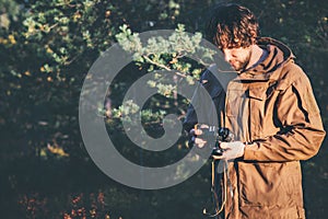 Young Man traveler with retro photo camera walking