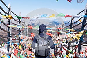 Young man traveler with sweater and backpack traveling in Shika snow mountain, happy Asian hiker enjoy in trip Zhongdian city