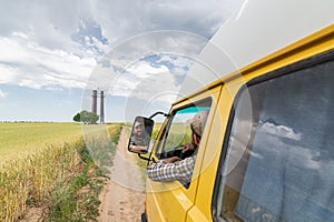 Young man travelling by campervan though the countryside