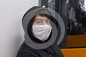 Young man travels in the subway with a protective mask