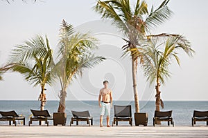 Young man in tropical resort at the Pacific Ocean