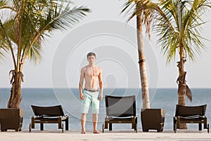 Young man in tropical resort at the Pacific Ocean