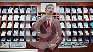 Young man try on classical suit in the suit shop