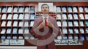 Young man try on classical suit in the suit shop