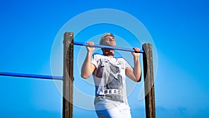 young man trying to do pullups