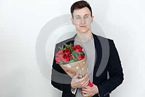 Young man with tulip bouquet, white background