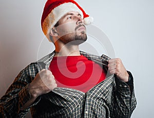 A young man turns into Santa Claus. Santa rips the shirt on his chest like a super hero