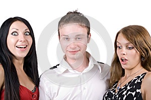 Young man and two surprised young women
