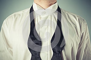 Young man tying a bow tie