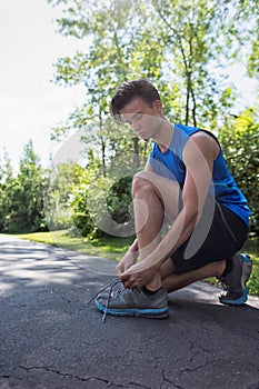 Young Man Tying His Sports Shoelace