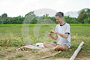 Young man is tying a rope