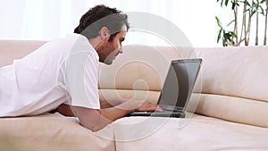 Young man typing on his laptop