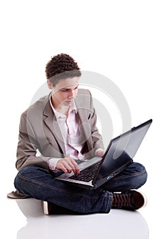 Young man typing and looking at screen of laptop