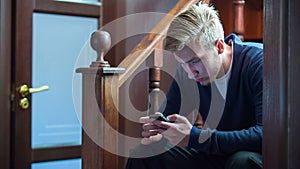 Young Man Typing On A Smartphone