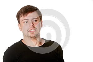 Young man with uncertain puzzled expression, isolated on white