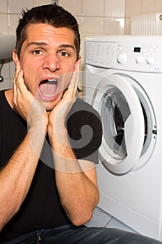 Young man unhappy with washing mashine