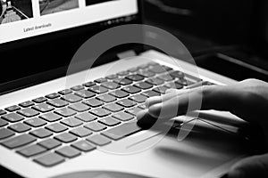 Young man uses laptop - black and white