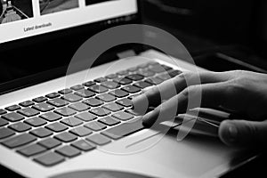 Young man uses laptop - black and white