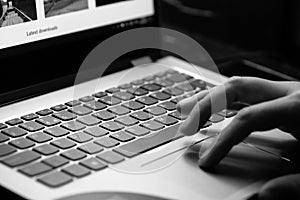 Young man uses laptop - black and white