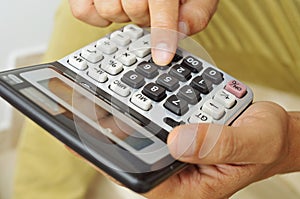 Young man using a calculator