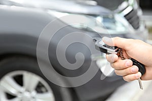 Young man using car alarm system