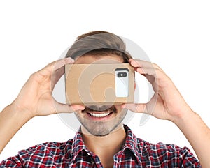 Young man using cardboard virtual reality headset
