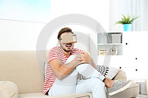 Young man using cardboard virtual reality headset