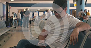 Young man using cell phone in airport lounge