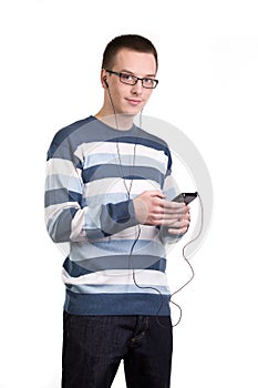 Young man using cell phone to listen to music