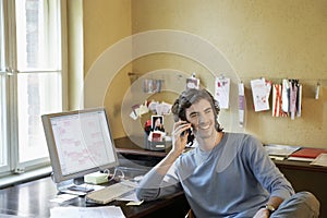Young man Using Cellphone In Office