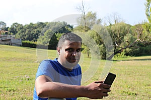 Young man using cellphone outdoor in park