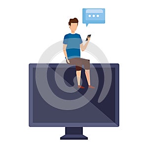 young man using cellphone seated in computer with speech bubble