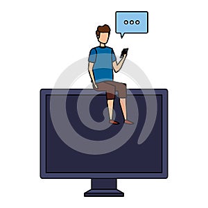 young man using cellphone seated in computer with speech bubble